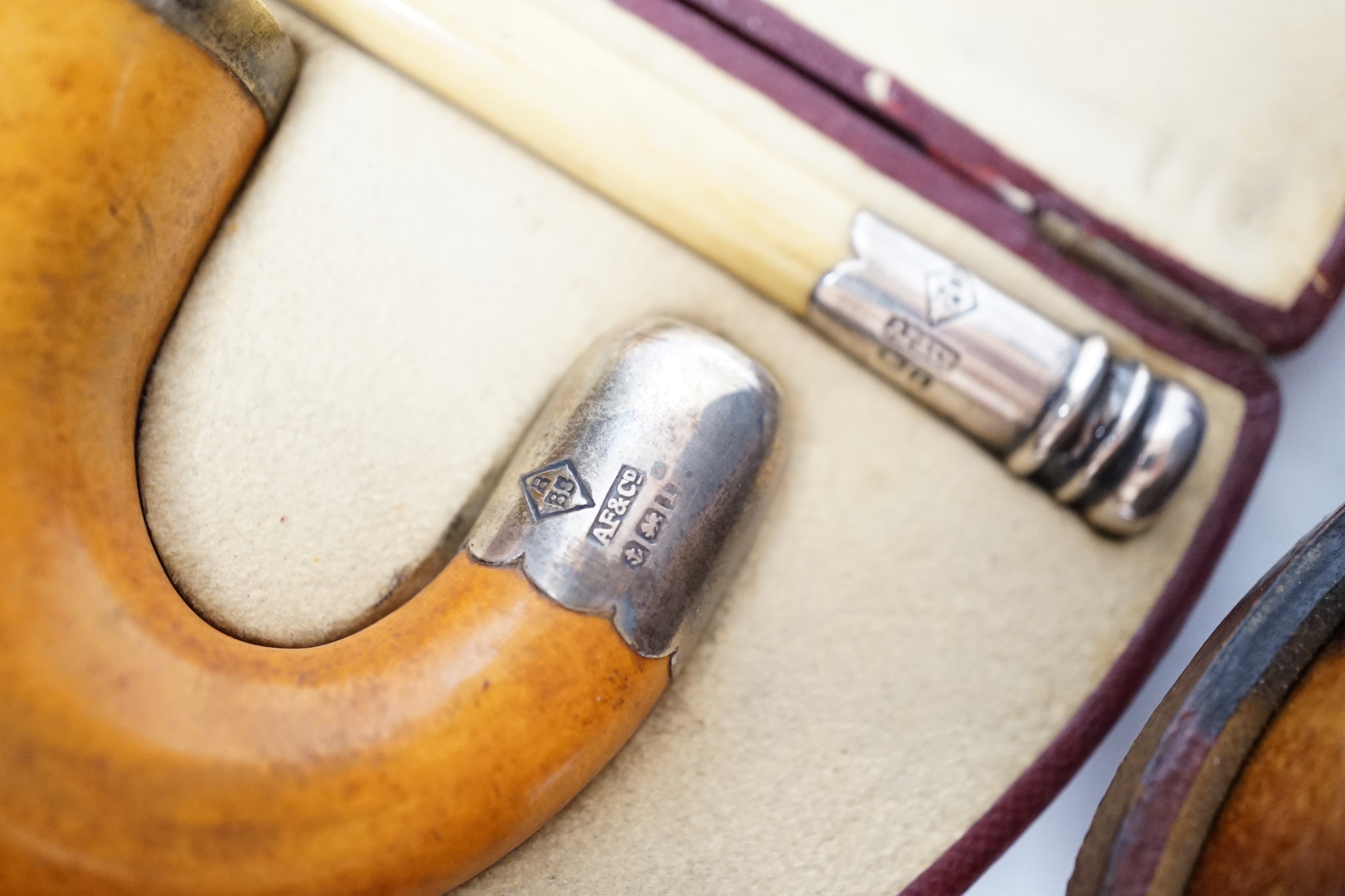 Three Meerschaum pipes, one 9ct gold mounted, one silver mounted, two cases